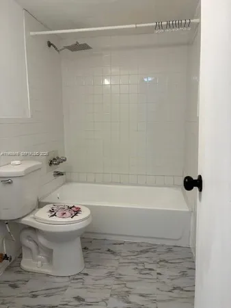 a bathroom with a sink a toilet and a bathtub