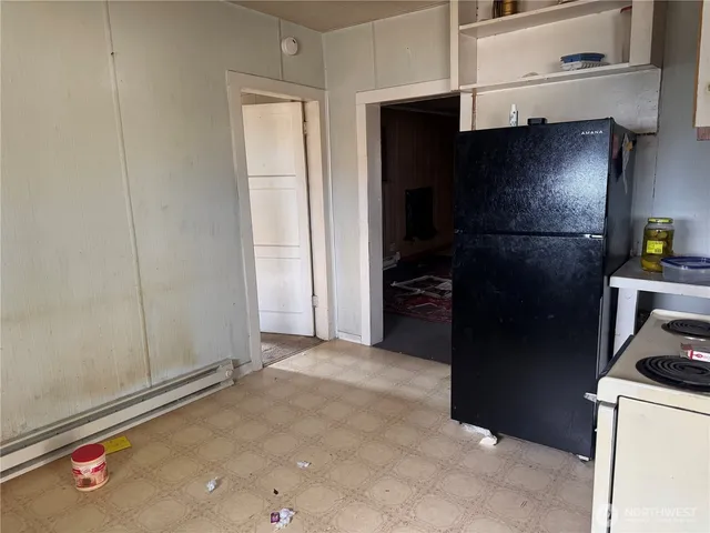a kitchen with a refrigerator and cabinets