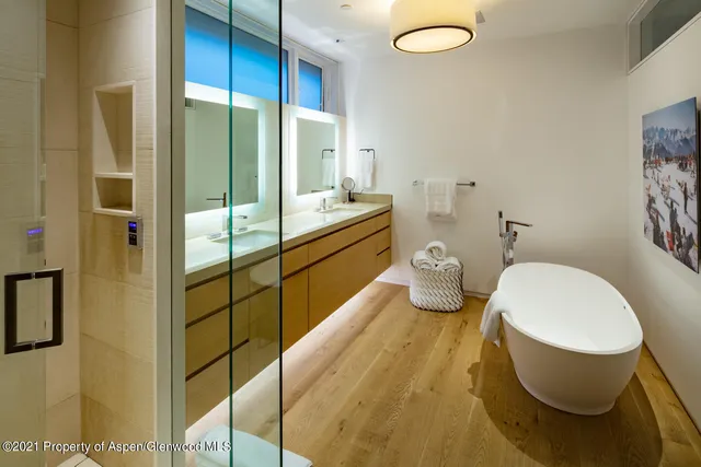 a spacious bathroom with a double vanity sink and a mirror