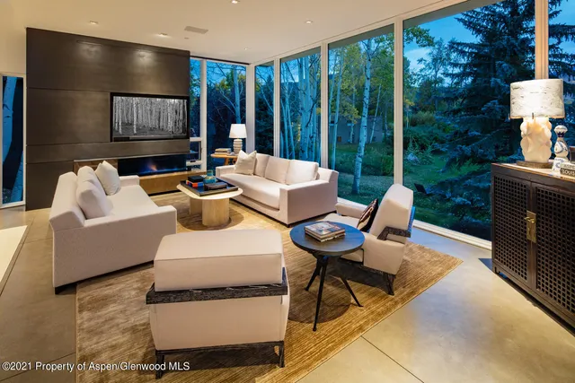 a living room with furniture and large window