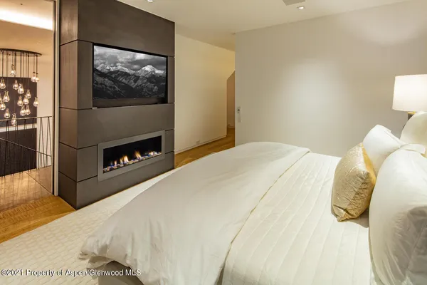 a bedroom with a bed and a television