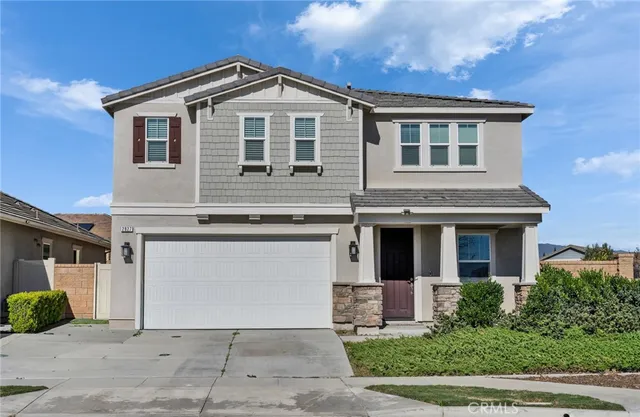a front view of a house with yard and parking