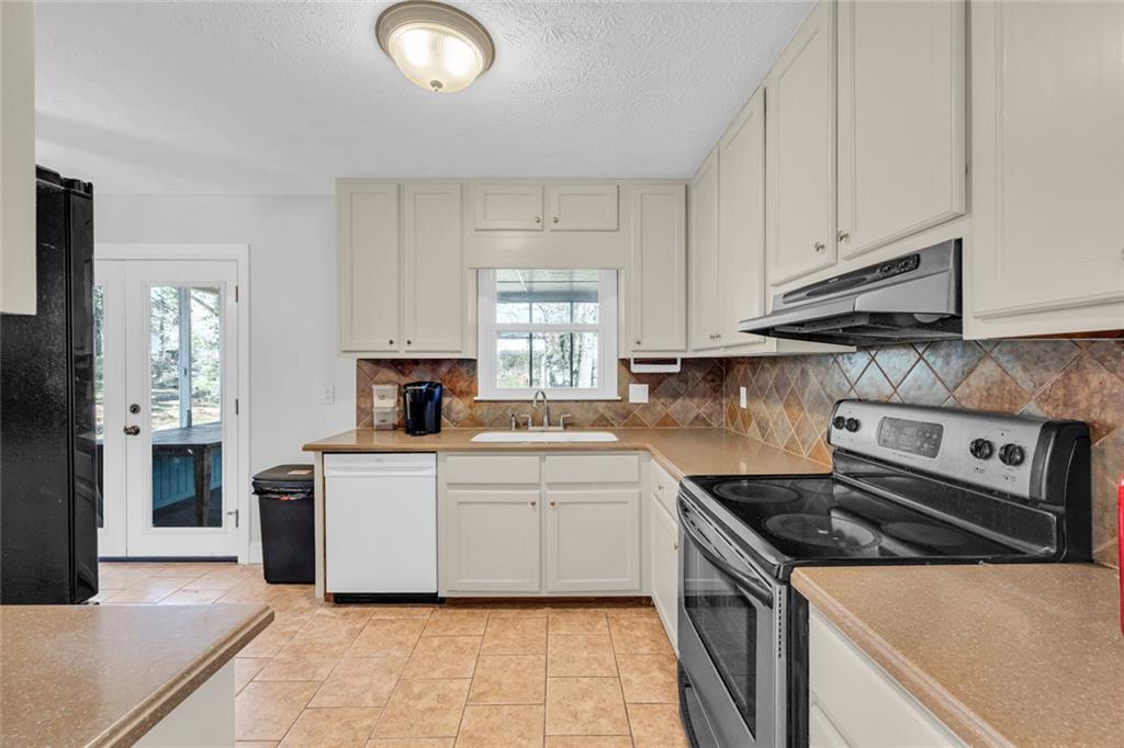 3765 Linwood Way Snellville, GA 30039 - Photo 21 of 53 a kitchen with a stove and a sink