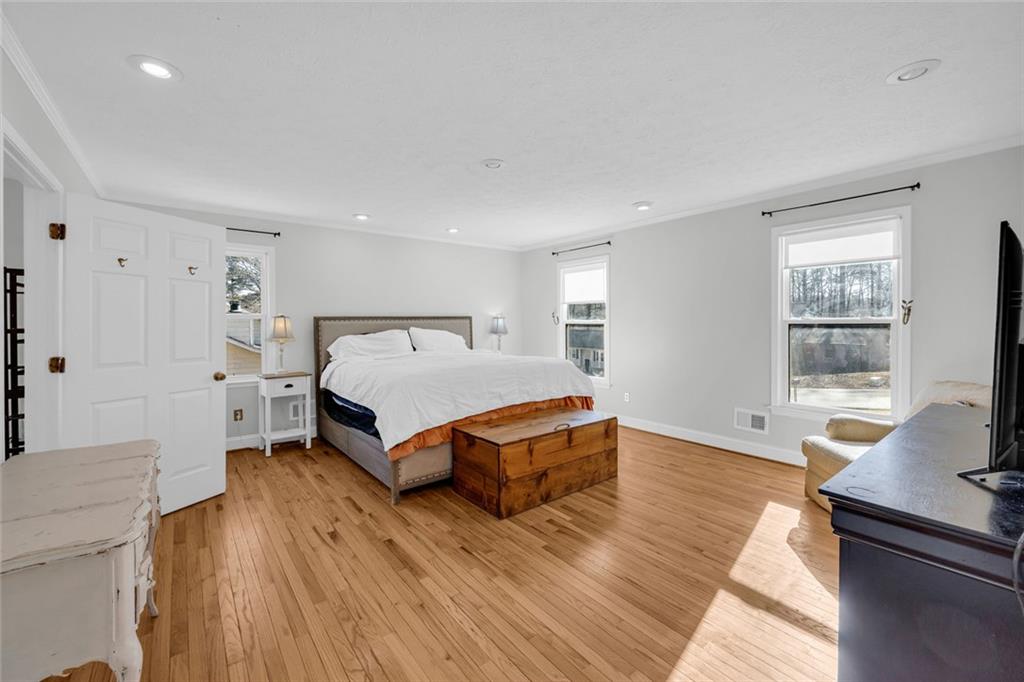 3765 Linwood Way Snellville, GA 30039 - Photo 23 of 53 a spacious bedroom with a bed and wooden floor