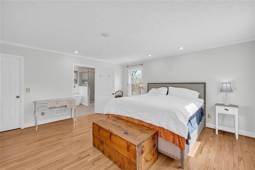 3765 Linwood Way Snellville, GA 30039 - Photo 25 of 53 a bedroom with a bed and wooden floor