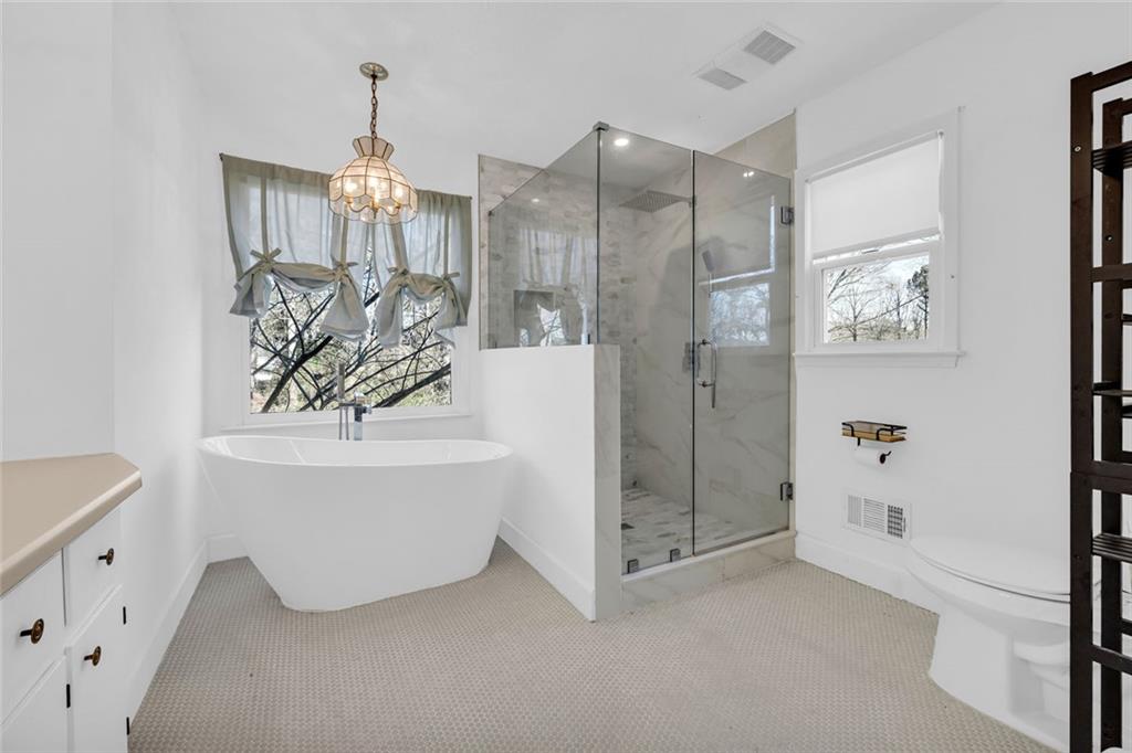 3765 Linwood Way Snellville, GA 30039 - Photo 28 of 53 a bathroom with a bathtub and shower