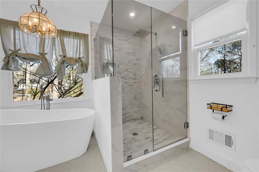 3765 Linwood Way Snellville, GA 30039 - Photo 29 of 53 a bathroom with a bathtub and shower