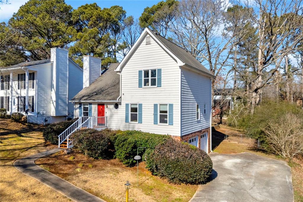 3765 Linwood Way Snellville, GA 30039 - Photo 3 of 53 a view of a house with a yard and large tree