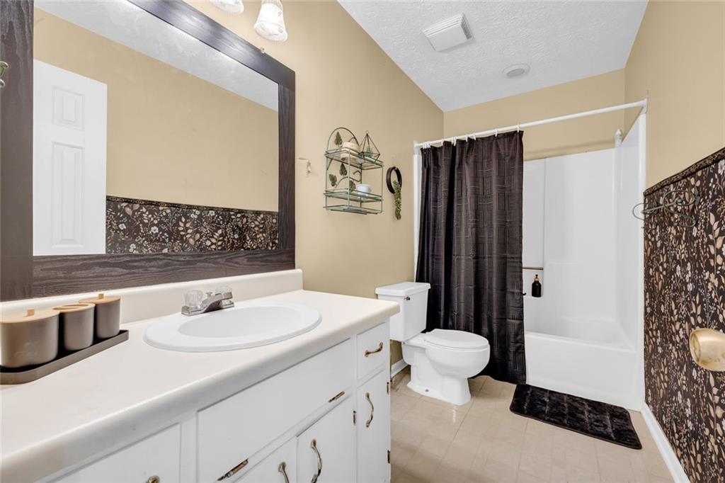 3765 Linwood Way Snellville, GA 30039 - Photo 35 of 53 a bathroom with a sink toilet and shower