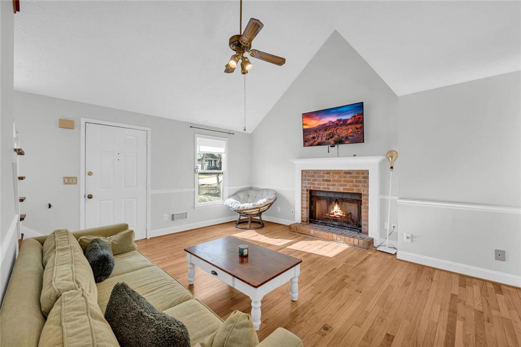 3765 Linwood Way Snellville, GA 30039 - Photo 9 of 53 a living room with furniture a flat screen tv and a fireplace