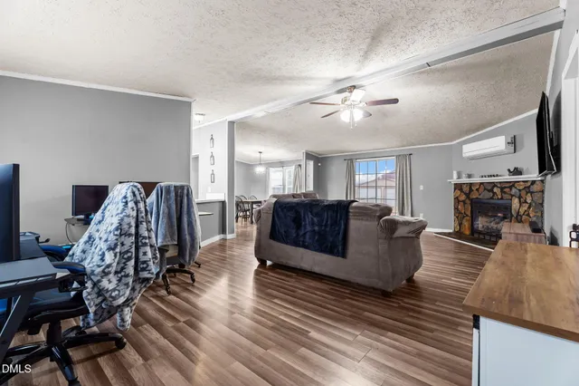 a living room with furniture fireplace and flat screen tv
