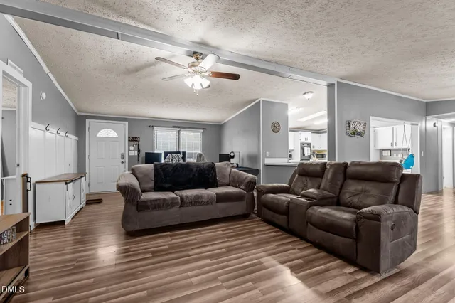 a living room with furniture and a wooden floor