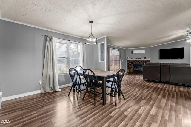 a view of a dining room with furniture window and wooden floor