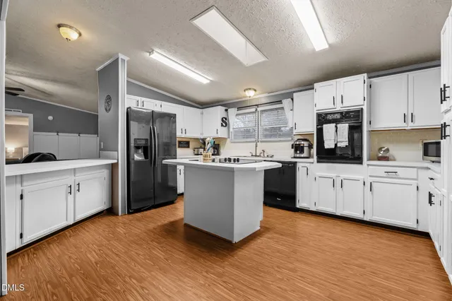 a kitchen with stainless steel appliances a refrigerator sink and cabinets