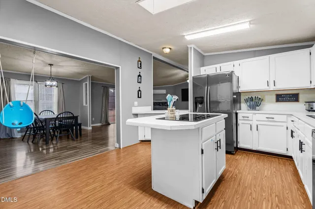 a kitchen with sink a cabinets and wooden floor