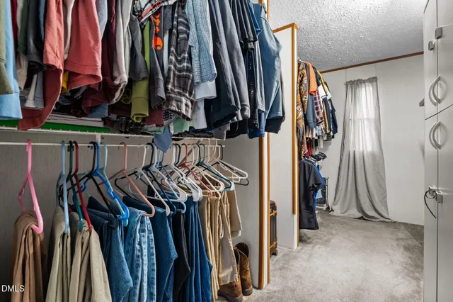 a view of walk in closet with clothes