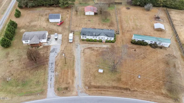 an aerial view of residential houses with outdoor space