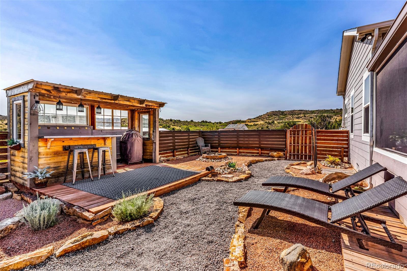 10380 Coyote Lane Rye, CO 81069 - Photo 30 of 50 a view of a balcony with chairs and wooden floor