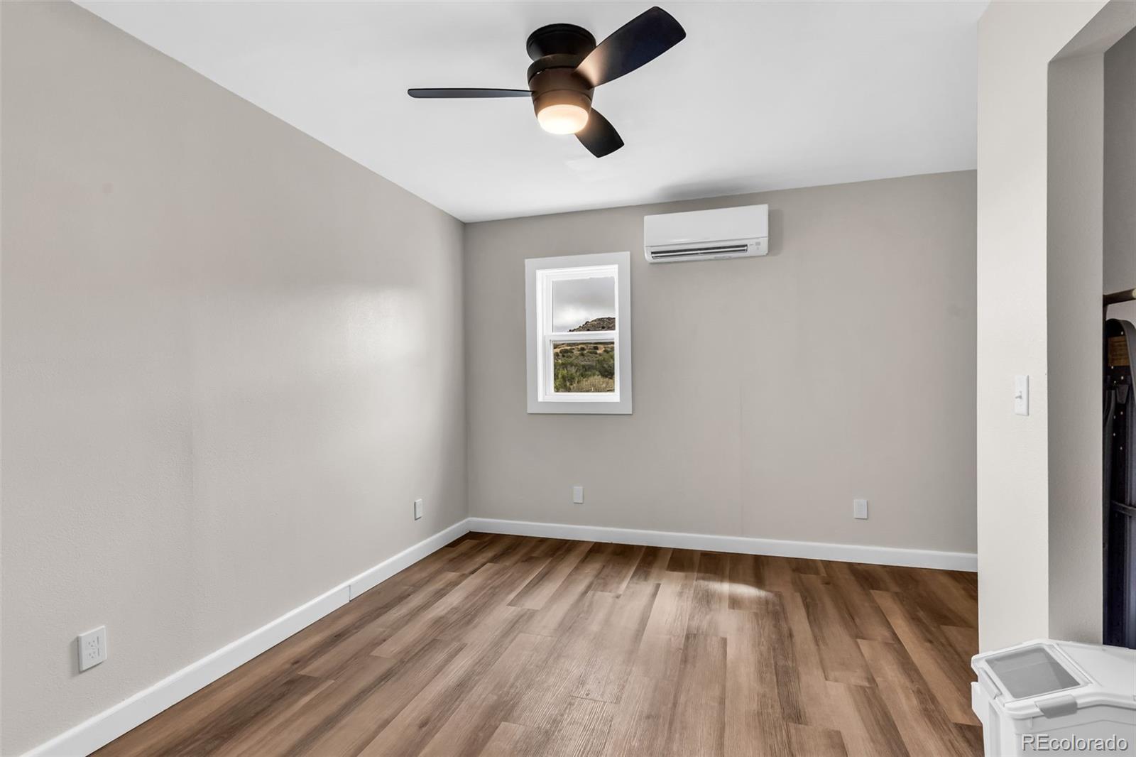 10380 Coyote Lane Rye, CO 81069 - Photo 45 of 50 an empty room with a window and a ceiling fan