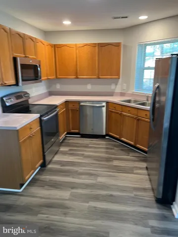 a kitchen with a stove a sink and a microwave