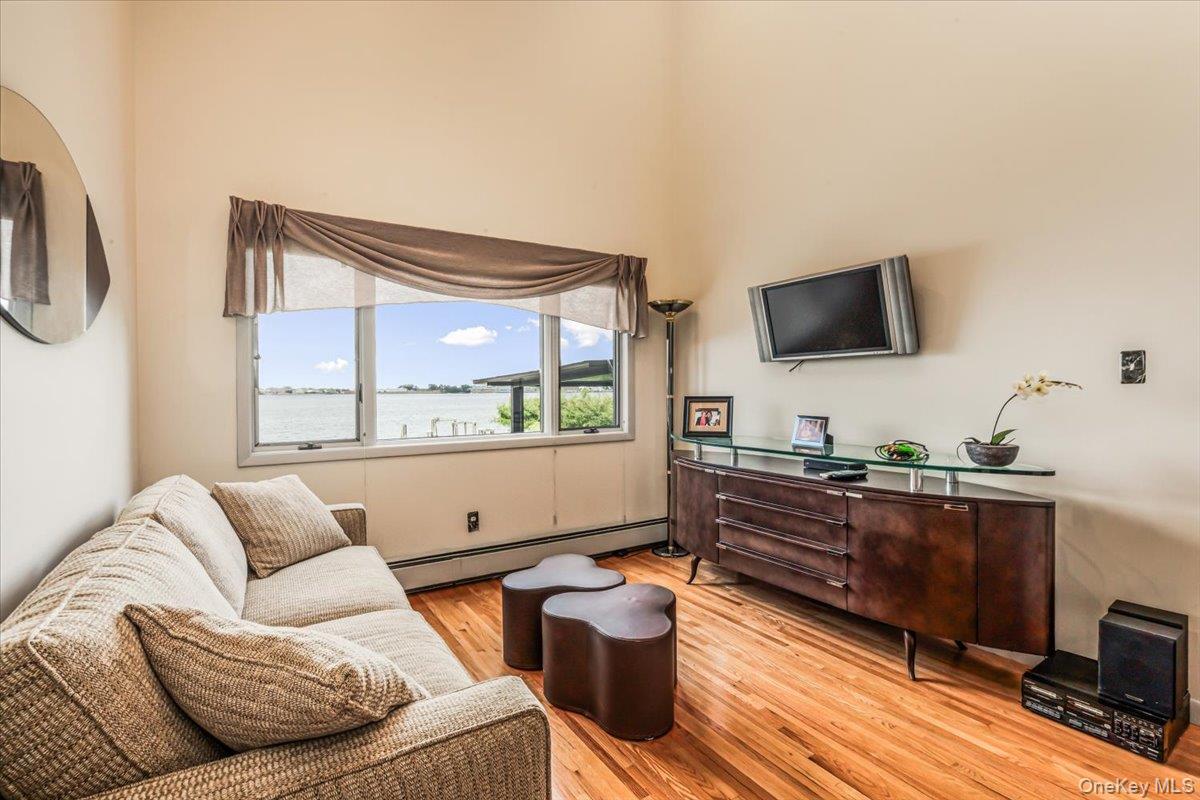 154-43 Riverside Drive Queens, NY 11357 - Photo 10 of 41 a living room with furniture and a flat screen tv