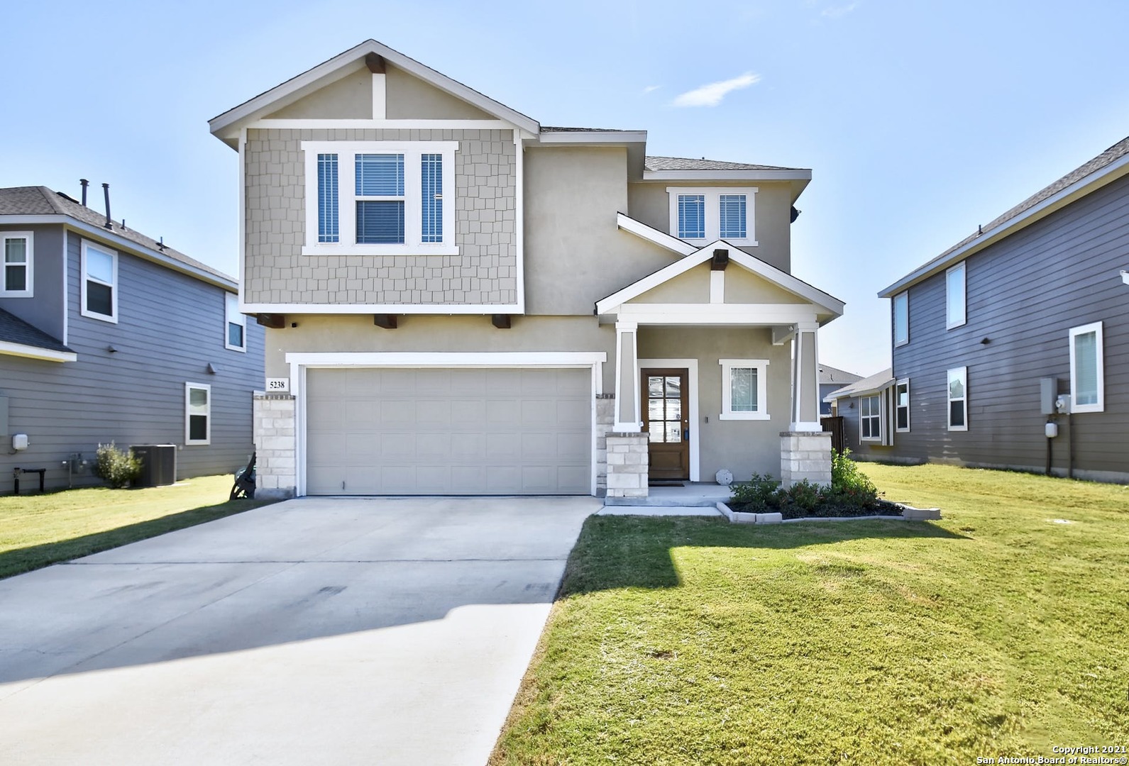 a view of a house with a yard patio and fire pit