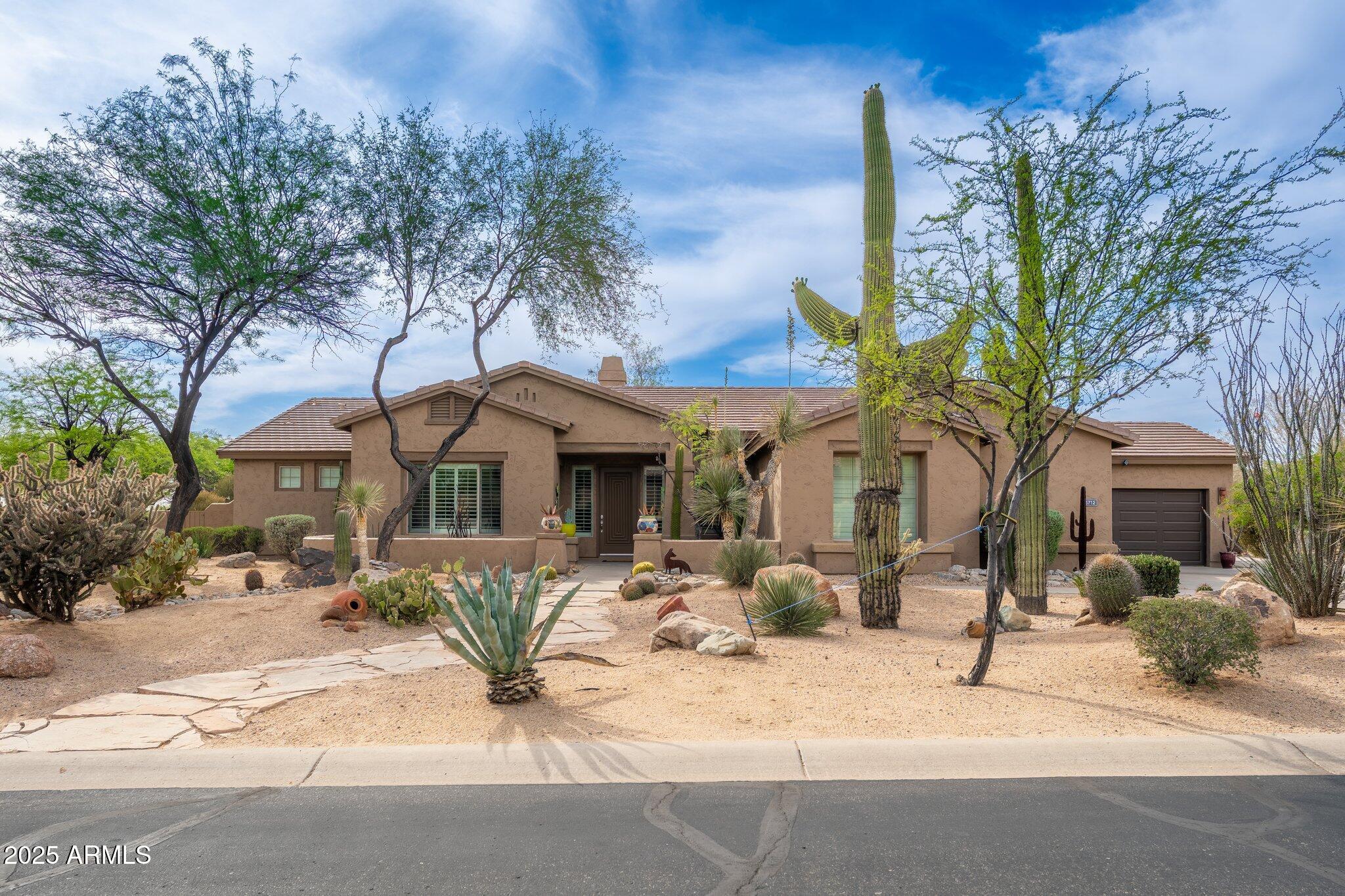 5712 East Blue Sky Drive Scottsdale, AZ 85266 - Photo 1 of 79 a view of a house with a yard covered in snow