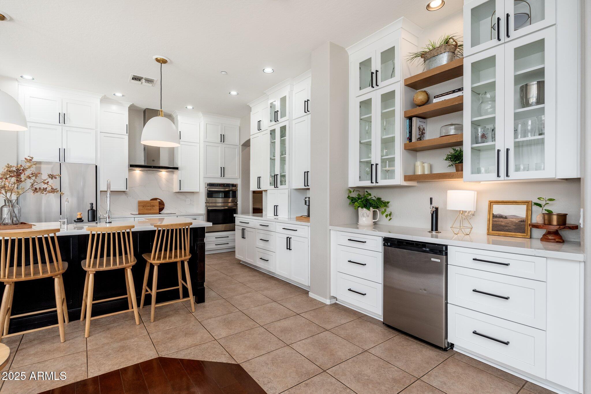 5712 East Blue Sky Drive Scottsdale, AZ 85266 - Photo 12 of 79 a large kitchen with a table and chairs