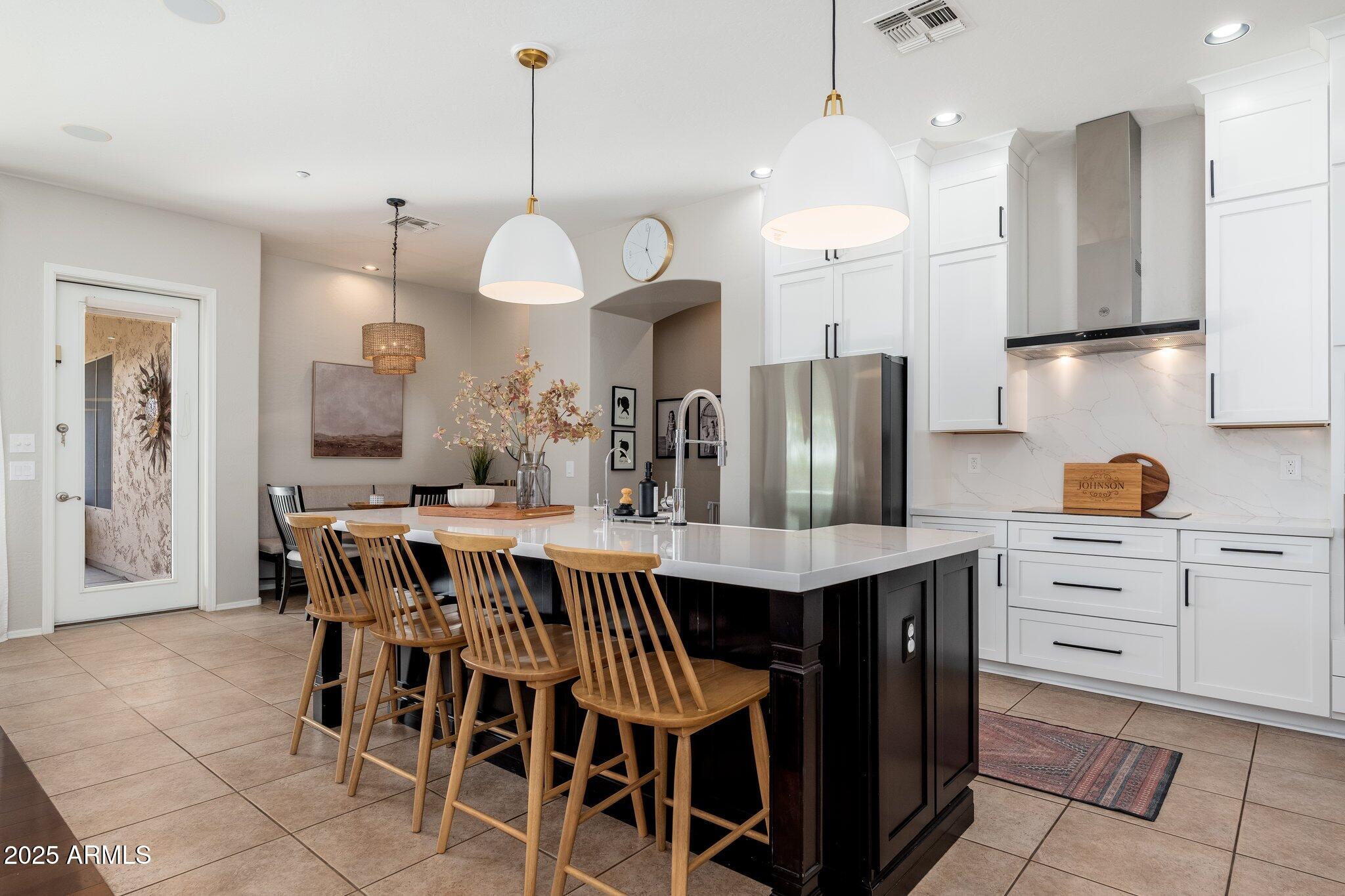 5712 East Blue Sky Drive Scottsdale, AZ 85266 - Photo 13 of 79 a kitchen with stainless steel appliances kitchen island a chandelier and refrigerator