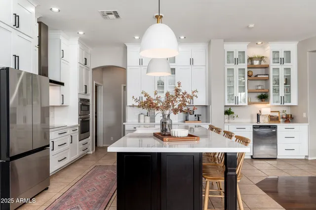 a kitchen with white cabinets stainless steel appliances and sink