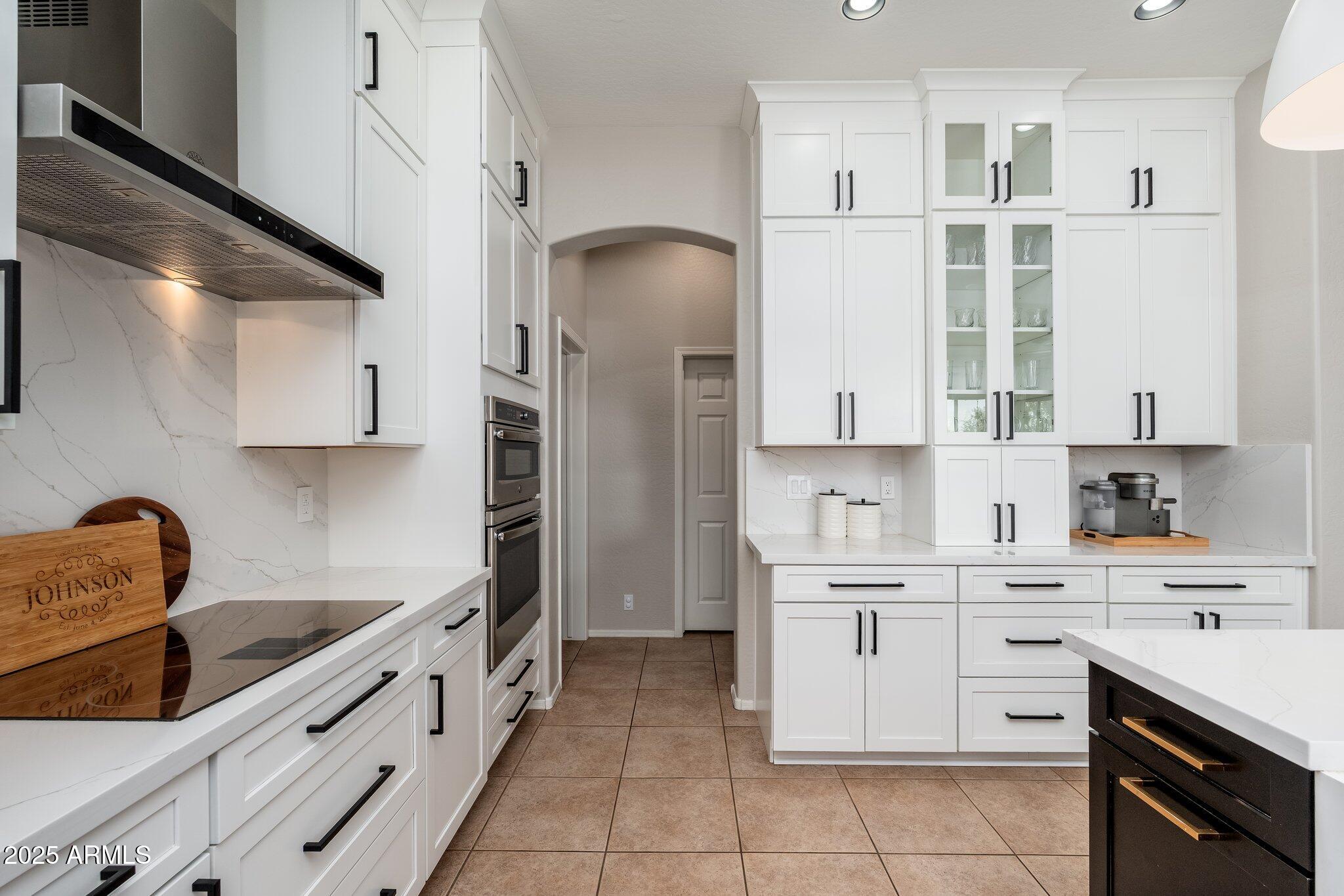 5712 East Blue Sky Drive Scottsdale, AZ 85266 - Photo 16 of 79 a kitchen with white cabinets stainless steel appliances and sink