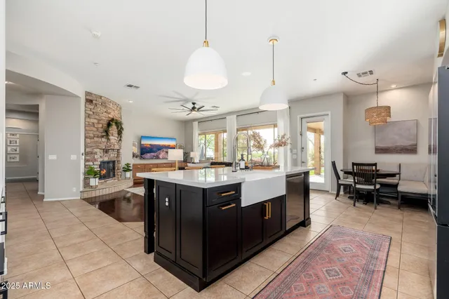 a bedroom with a bed a fireplace and a flat screen tv