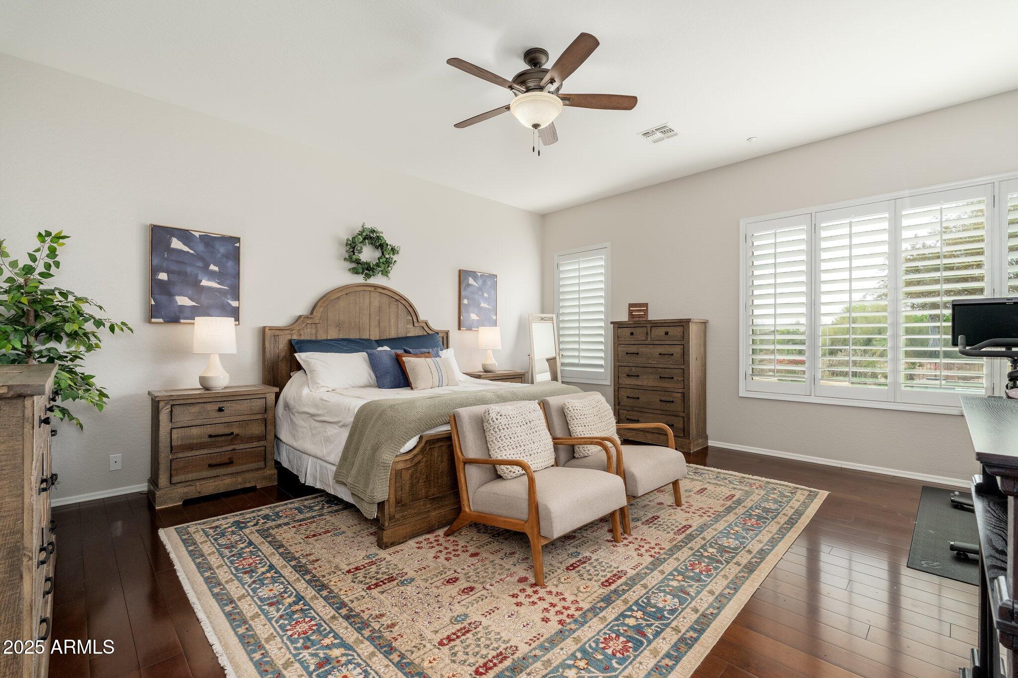 5712 East Blue Sky Drive Scottsdale, AZ 85266 - Photo 19 of 79 a bedroom with a bed and wooden floor