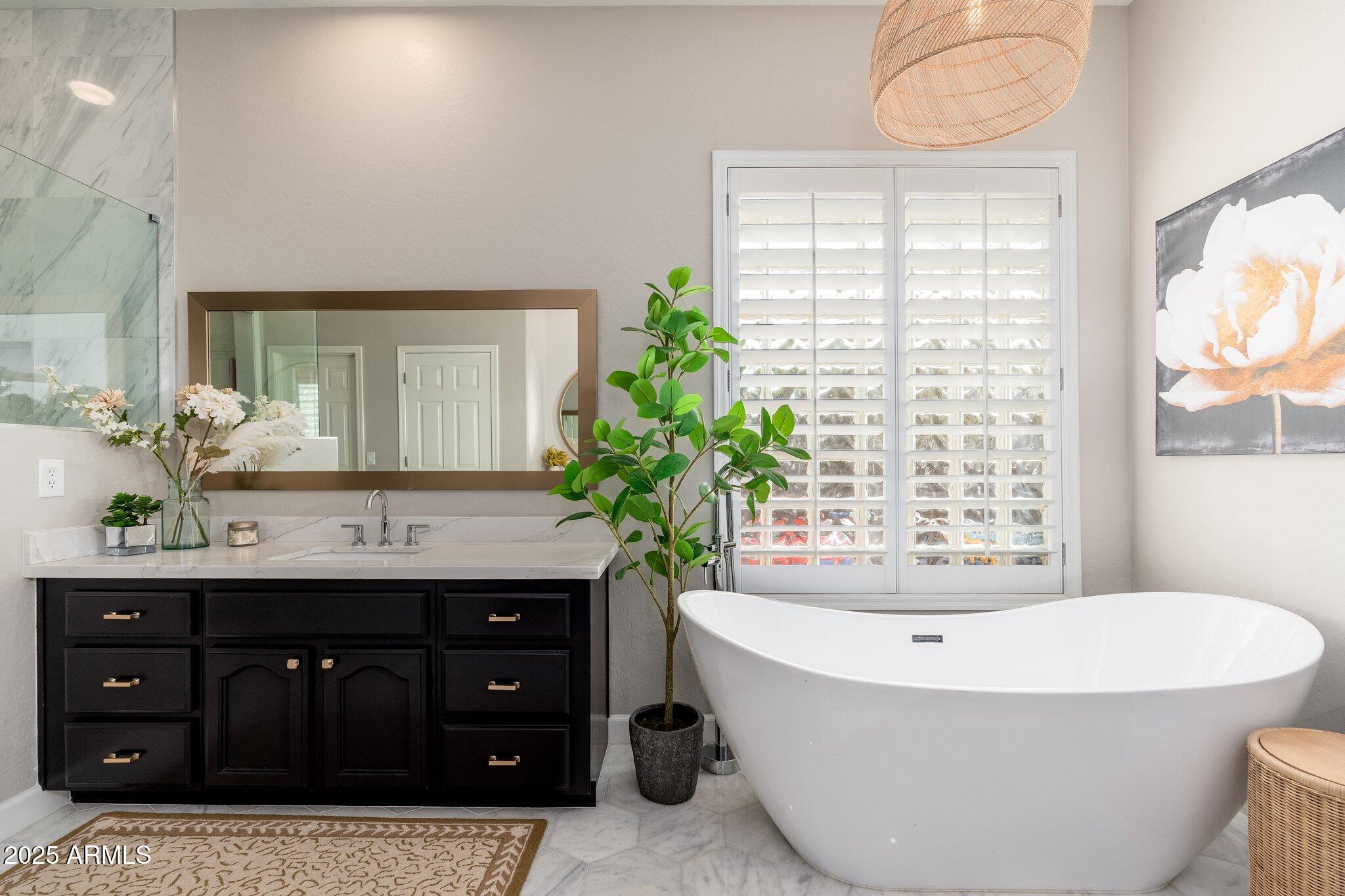 5712 East Blue Sky Drive Scottsdale, AZ 85266 - Photo 24 of 79 a bathroom with a tub sink and mirror