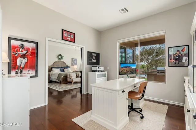 a view of a livingroom with a hardwood floor and hallway