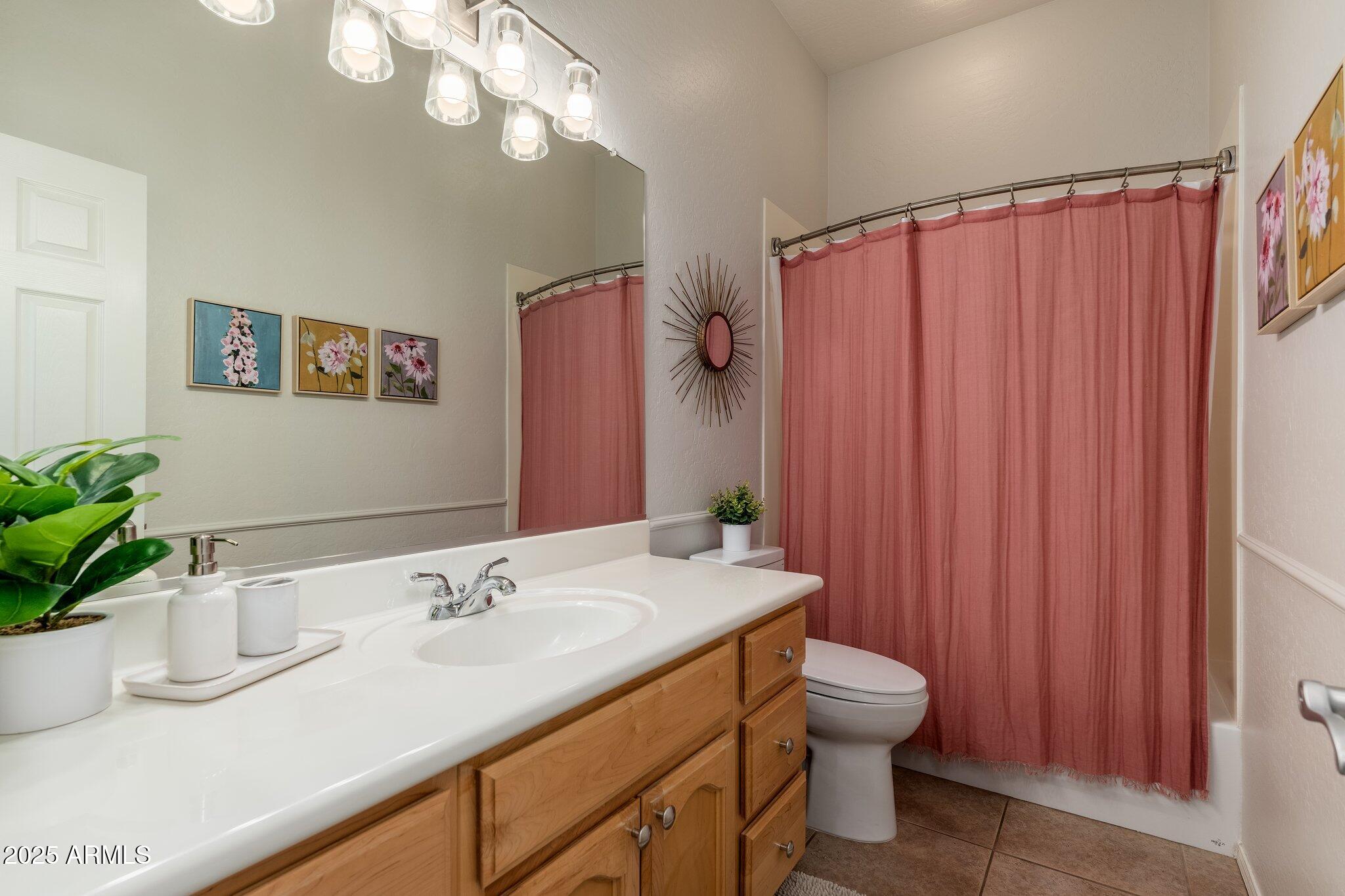 5712 East Blue Sky Drive Scottsdale, AZ 85266 - Photo 31 of 79 a bathroom with a granite countertop sink a toilet and a mirror