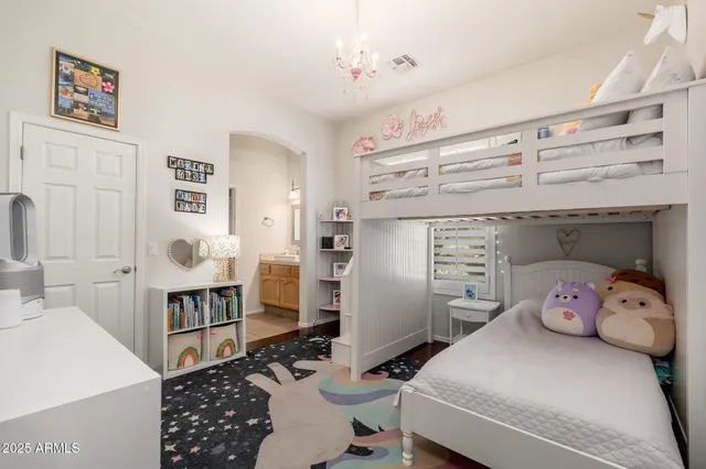 a living room with furniture a wooden floor and a large window