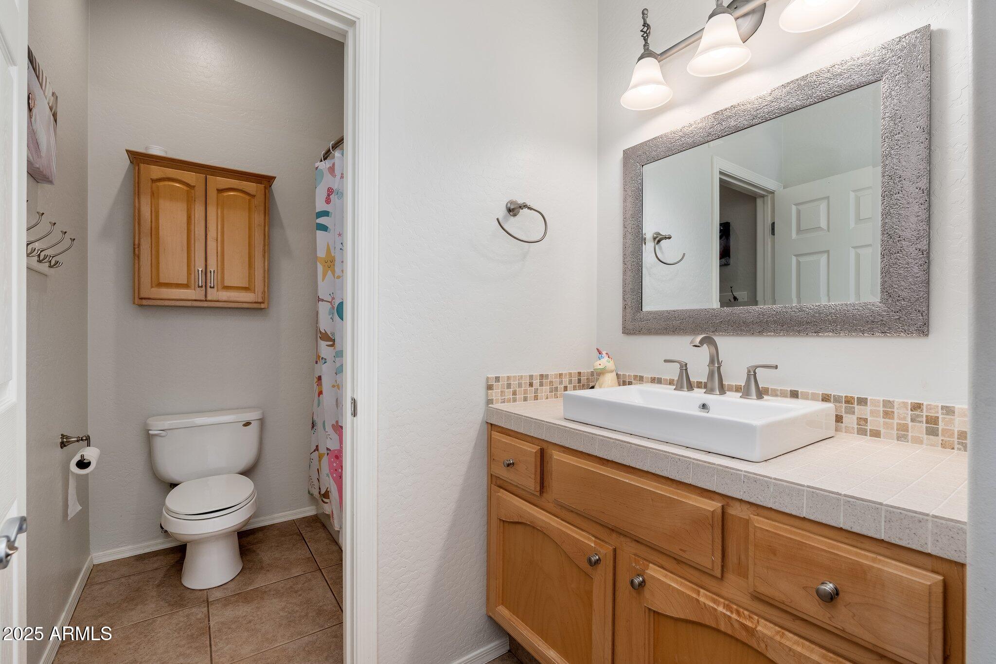5712 East Blue Sky Drive Scottsdale, AZ 85266 - Photo 34 of 79 a bathroom with a toilet sink and mirror