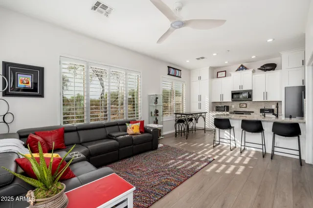 a living room with furniture and a large window