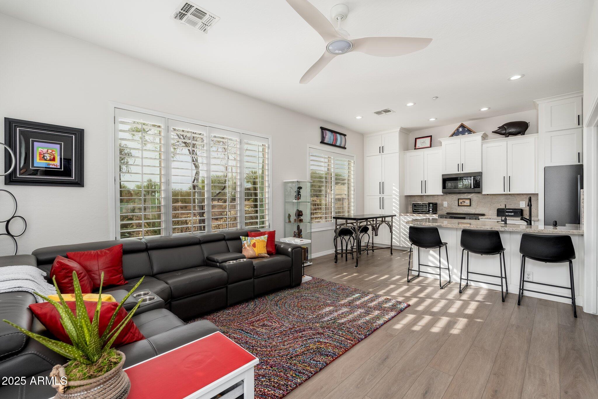 5712 East Blue Sky Drive Scottsdale, AZ 85266 - Photo 42 of 79 a living room with furniture a wooden floor and a large window