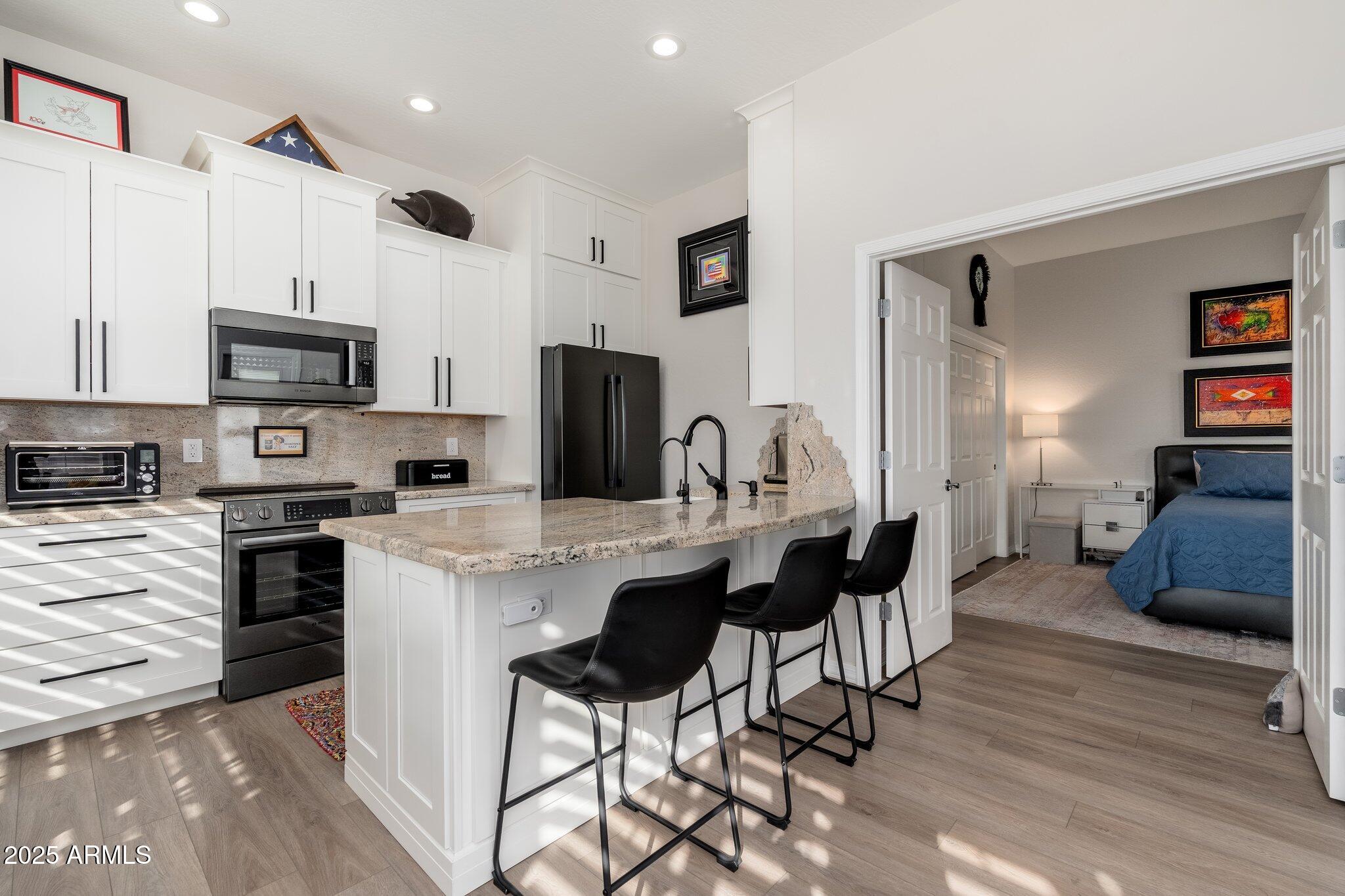 5712 East Blue Sky Drive Scottsdale, AZ 85266 - Photo 44 of 79 a kitchen with stainless steel appliances a stove a sink a microwave a refrigerator and cabinets