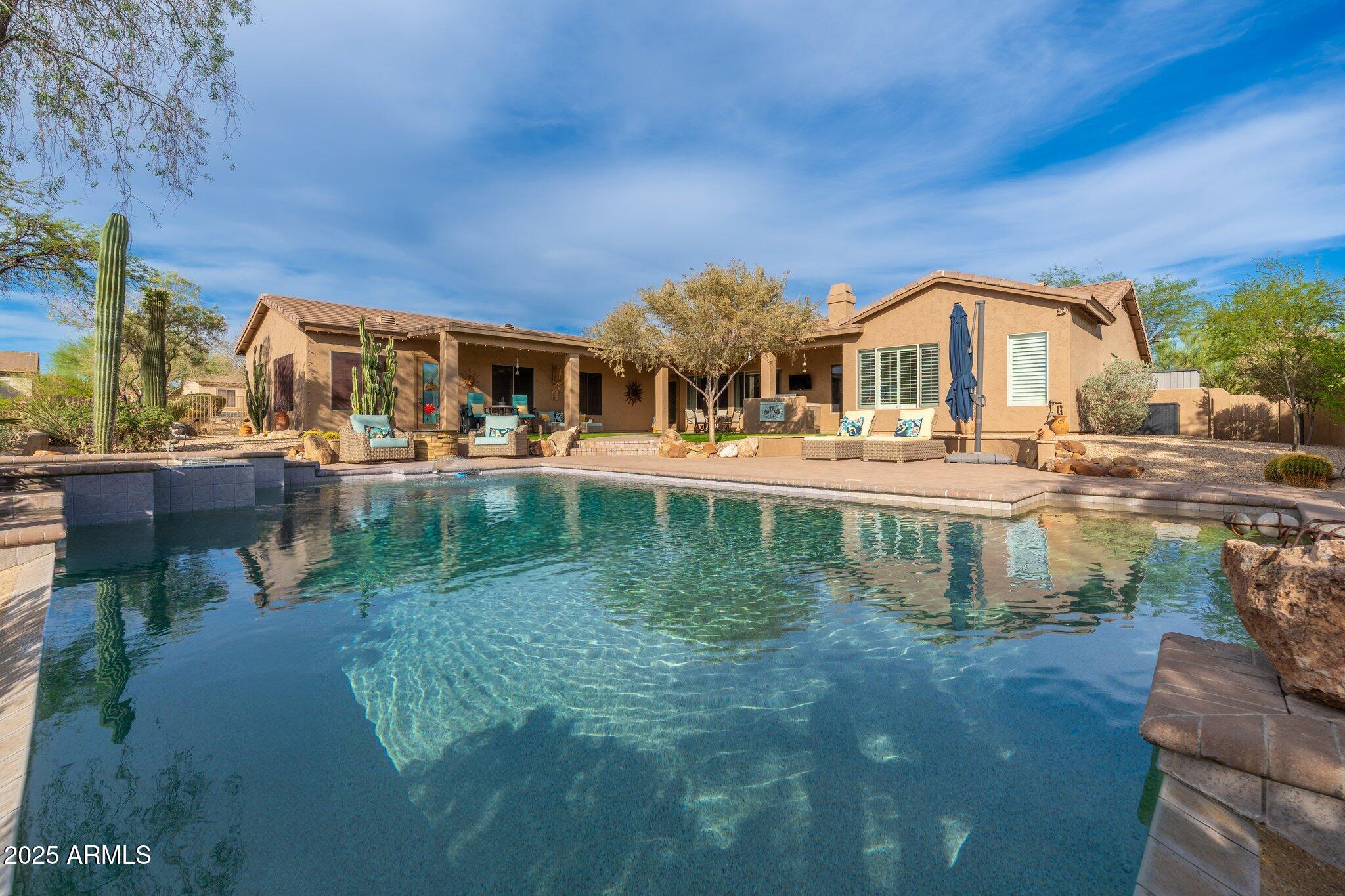 5712 East Blue Sky Drive Scottsdale, AZ 85266 - Photo 55 of 79 a view of a lake with a building in the background