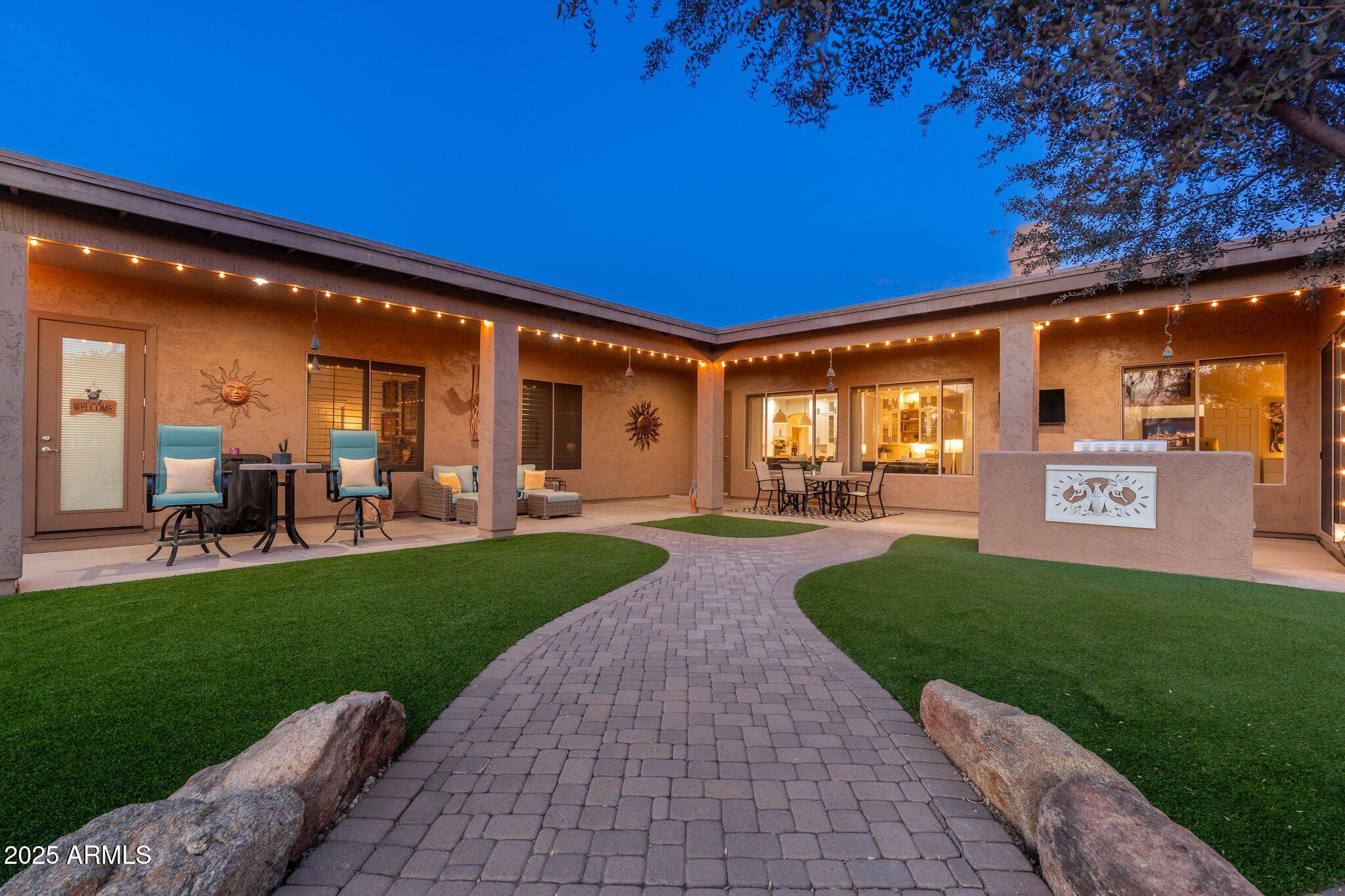 5712 East Blue Sky Drive Scottsdale, AZ 85266 - Photo 66 of 79 a view of a patio with table and chairs and potted plants
