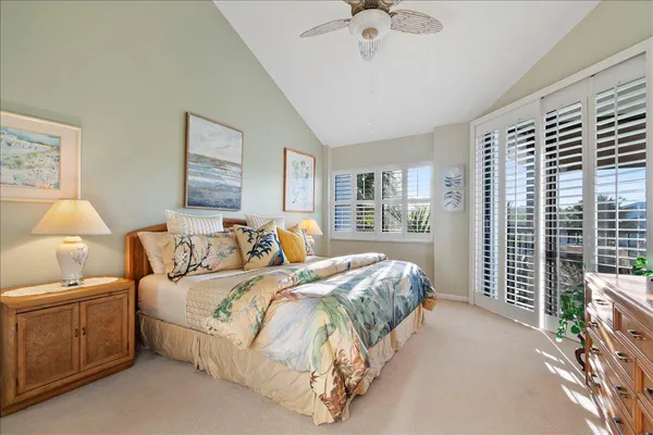 a spacious bedroom with a bed and a chandelier