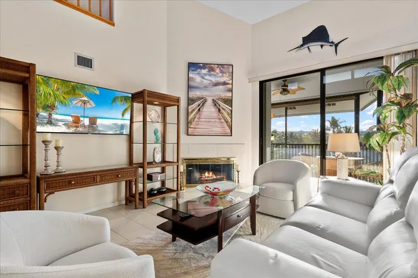 a living room with furniture fireplace and a large window