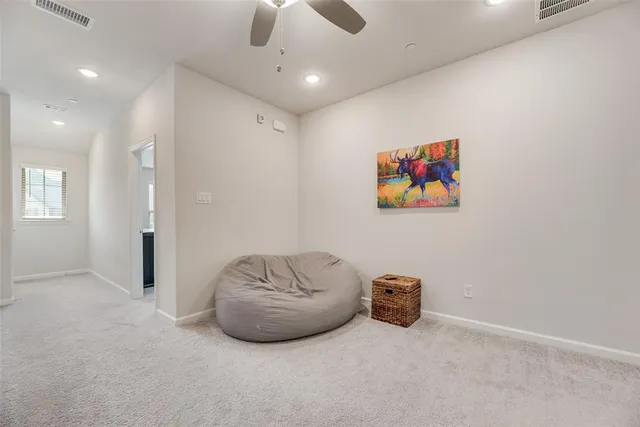 a view of room with a ceiling fan and window