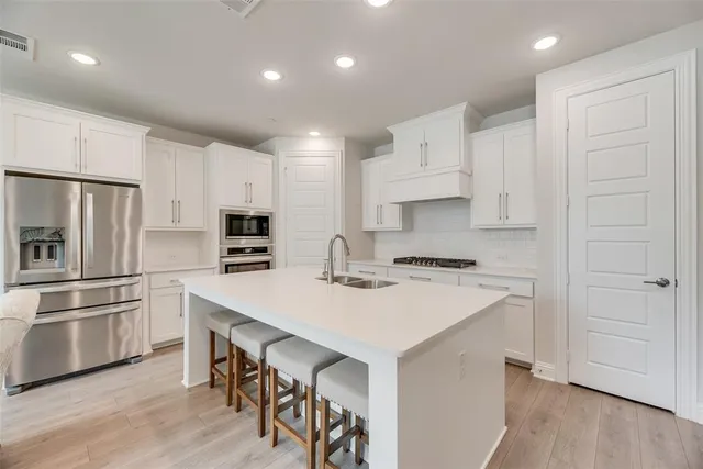 a kitchen with a refrigerator a stove a sink and a refrigerator