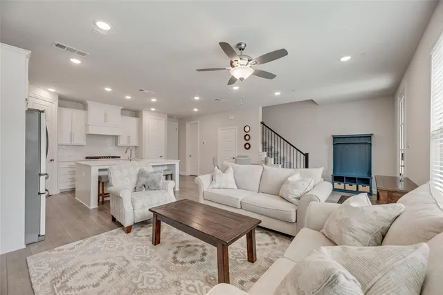 a living room with furniture and kitchen view
