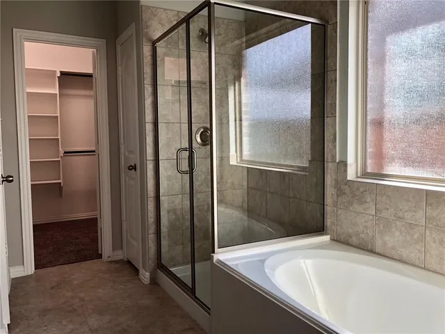 a bathroom with a bathtub and shower
