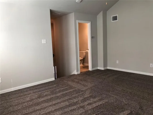 a view of a room with wooden floor and closet